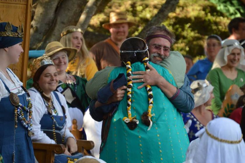 Myself and my Laurel hugging in SCA Royal Court.